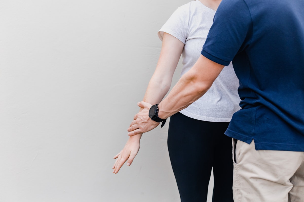 Rehabilitation specialist demonstrating joint care exercises